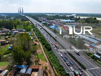 A large number of vehicles move slowly along an expressway in Huai'an, China, on October 1, 2024. (