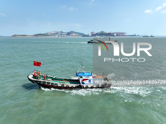 Police aboard a ''Hongfan 110'' boat conduct a maritime patrol operation in Zhoushan, China, on October 1, 2024. (