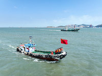 Police aboard a ''Hongfan 110'' boat conduct a maritime patrol operation in Zhoushan, China, on October 1, 2024. (