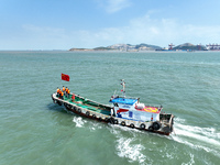 Police aboard a ''Hongfan 110'' boat conduct a maritime patrol operation in Zhoushan, China, on October 1, 2024. (