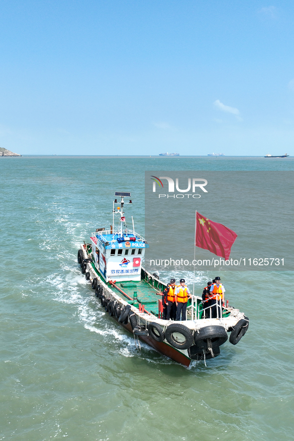 Police aboard a ''Hongfan 110'' boat conduct a maritime patrol operation in Zhoushan, China, on October 1, 2024. 