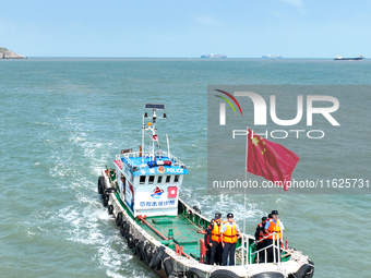 Police aboard a ''Hongfan 110'' boat conduct a maritime patrol operation in Zhoushan, China, on October 1, 2024. (