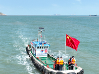 Police aboard a ''Hongfan 110'' boat conduct a maritime patrol operation in Zhoushan, China, on October 1, 2024. (