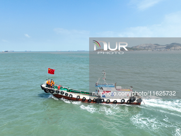 Police aboard a ''Hongfan 110'' boat conduct a maritime patrol operation in Zhoushan, China, on October 1, 2024. 