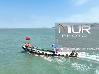 Police aboard a ''Hongfan 110'' boat conduct a maritime patrol operation in Zhoushan, China, on October 1, 2024. (