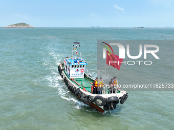 Police aboard a ''Hongfan 110'' boat conduct a maritime patrol operation in Zhoushan, China, on October 1, 2024. (