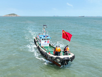 Police aboard a ''Hongfan 110'' boat conduct a maritime patrol operation in Zhoushan, China, on October 1, 2024. (