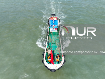 Police aboard a ''Hongfan 110'' boat conduct a maritime patrol operation in Zhoushan, China, on October 1, 2024. (