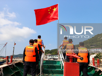 Police aboard a ''Hongfan 110'' boat conduct a maritime patrol operation in Zhoushan, China, on October 1, 2024. (