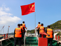 Police aboard a ''Hongfan 110'' boat conduct a maritime patrol operation in Zhoushan, China, on October 1, 2024. (