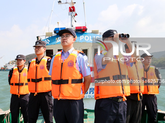 Police aboard a ''Hongfan 110'' boat conduct a maritime patrol operation in Zhoushan, China, on October 1, 2024. (