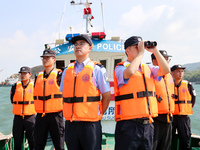 Police aboard a ''Hongfan 110'' boat conduct a maritime patrol operation in Zhoushan, China, on October 1, 2024. (