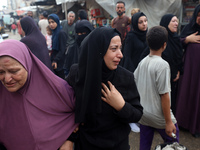 Relatives of Palestinians who are killed following the Israeli attack on the Nuseirat refugee camp mourn after the bodies are transferred to...