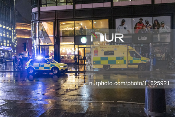 Ambulance in London. Emergency Services Ambulance Vehicle of NHS London Ambulance Service spotted during the night flashing blue light and u...