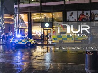 Ambulance in London. Emergency Services Ambulance Vehicle of NHS London Ambulance Service spotted during the night flashing blue light and u...