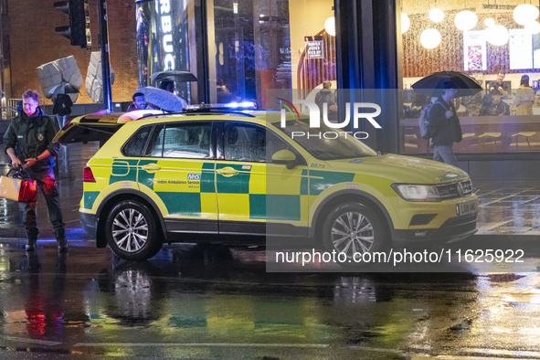 Paramedic, Medical worker and an Ambulance in London. Emergency Services Ambulance Vehicle of NHS London Ambulance Service spotted during th...