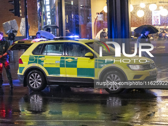 Paramedic, Medical worker and an Ambulance in London. Emergency Services Ambulance Vehicle of NHS London Ambulance Service spotted during th...