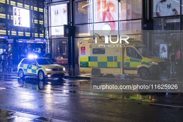 Ambulance in London. Emergency Services Ambulance Vehicle of NHS London Ambulance Service spotted during the night flashing blue light and u...