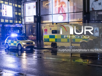 Ambulance in London. Emergency Services Ambulance Vehicle of NHS London Ambulance Service spotted during the night flashing blue light and u...