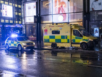 Ambulance in London. Emergency Services Ambulance Vehicle of NHS London Ambulance Service spotted during the night flashing blue light and u...