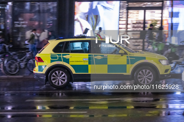 Ambulance in London. Emergency Services Ambulance Vehicle of NHS London Ambulance Service spotted during the night in the streets of Soho in...