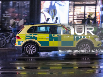 Ambulance in London. Emergency Services Ambulance Vehicle of NHS London Ambulance Service spotted during the night in the streets of Soho in...