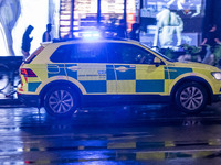 Ambulance in London. Emergency Services Ambulance Vehicle of NHS London Ambulance Service spotted during the night flashing blue light and u...