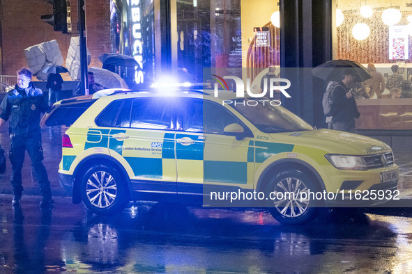 Paramedic, Medical worker next to an Ambulance in London. Emergency Services Ambulance Vehicle of NHS London Ambulance Service spotted durin...