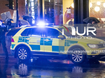 Paramedic, Medical worker next to an Ambulance in London. Emergency Services Ambulance Vehicle of NHS London Ambulance Service spotted durin...