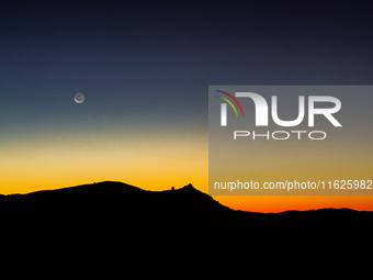 C/2023 A3 (Tsuchinshan-ATLAS) comet and waning moon are seen before sunrise above Rocca Calascio castle and Santa Maria della Pieta church i...