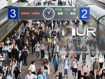 Tourists travel at Nanjing Railway Station in Nanjing, China, on October 1, 2024. (