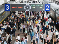 Tourists travel at Nanjing Railway Station in Nanjing, China, on October 1, 2024. (