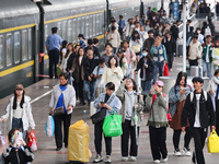 Tourists travel at Nanjing Railway Station in Nanjing, China, on October 1, 2024. (