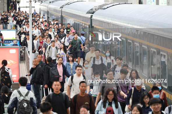 Tourists travel at Nanjing Railway Station in Nanjing, China, on October 1, 2024. 