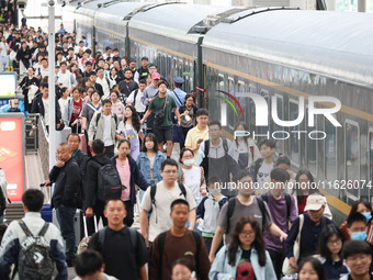 Tourists travel at Nanjing Railway Station in Nanjing, China, on October 1, 2024. (