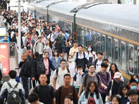 Tourists travel at Nanjing Railway Station in Nanjing, China, on October 1, 2024. (