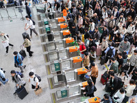 Tourists travel at Nanjing Railway Station in Nanjing, China, on October 1, 2024. (