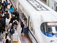 Tourists travel at Nanjing Railway Station in Nanjing, China, on October 1, 2024. (