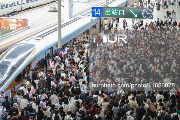 Tourists travel at Nanjing Railway Station in Nanjing, China, on October 1, 2024. 