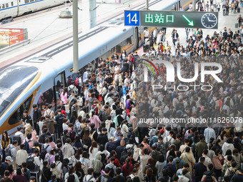 Tourists travel at Nanjing Railway Station in Nanjing, China, on October 1, 2024. (