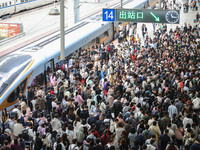 Tourists travel at Nanjing Railway Station in Nanjing, China, on October 1, 2024. (