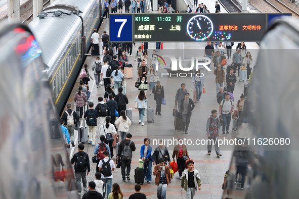 Tourists travel at Nanjing Railway Station in Nanjing, China, on October 1, 2024. 