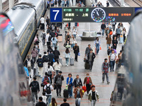 Tourists travel at Nanjing Railway Station in Nanjing, China, on October 1, 2024. (