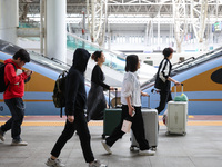 Tourists travel at Nanjing Railway Station in Nanjing, China, on October 1, 2024. (