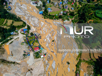 The aerial view shows the flood-affected areas of the Nakhu River in the Tikabhairab region of southern Lalitpur, Nepal, on October 01, 2024...