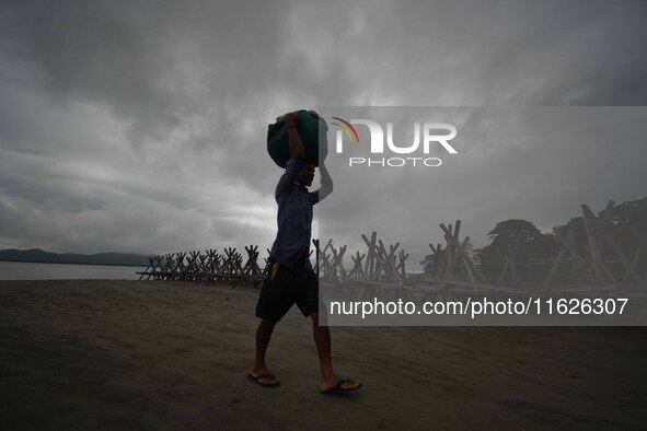 Rain clouds loom over the Brahmaputra River in Guwahati, Assam, India, on May 25, 2018. 