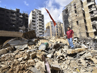 The destruction at the site of an overnight Israeli airstrike on the Laylaki, Harat Hreik, and Sant Tares neighborhoods in Beirut's southern...