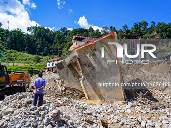 Nakhu River flooding damages homes in the Tikabhairab region of southern Lalitpur, Nepal, on October 01, 2024. Homes are severely damaged, w...