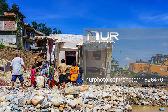 People search for their belongings in damaged houses after Nakhu River flooding in the Tikabhairab region of southern Lalitpur, Nepal, on Oc...