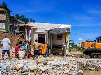 People search for their belongings in damaged houses after Nakhu River flooding in the Tikabhairab region of southern Lalitpur, Nepal, on Oc...